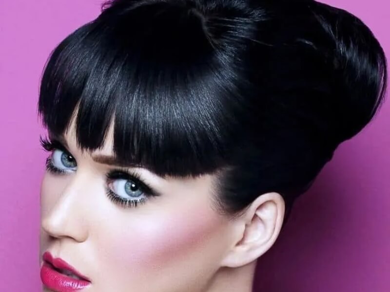 Elegant updo with black hair and blue eyes