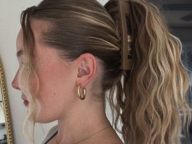 Classic ponytail is secured with a large claw clip