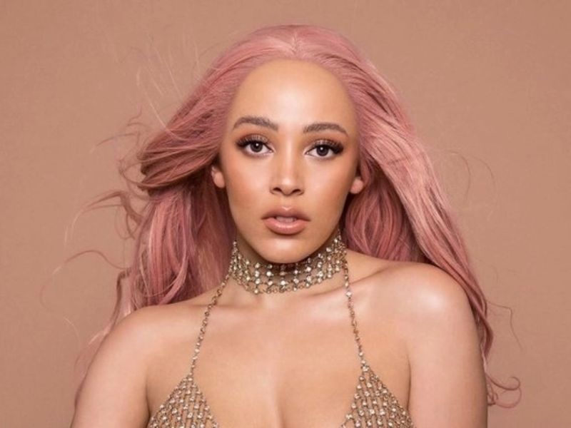 Doja Cat with gold pink curly wig