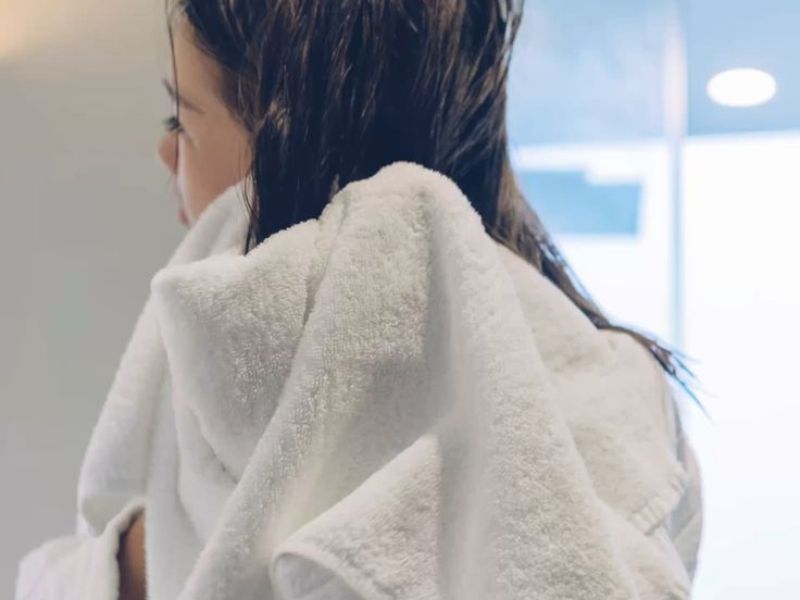 Rubbing your hair with a towel can cause friction and damage the strands.