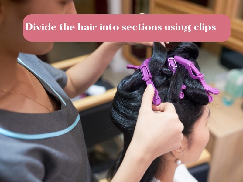 Divide the hair with clips for better styling and uniform curls