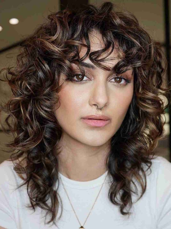 Let your natural curls take center stage with a voluminous cut