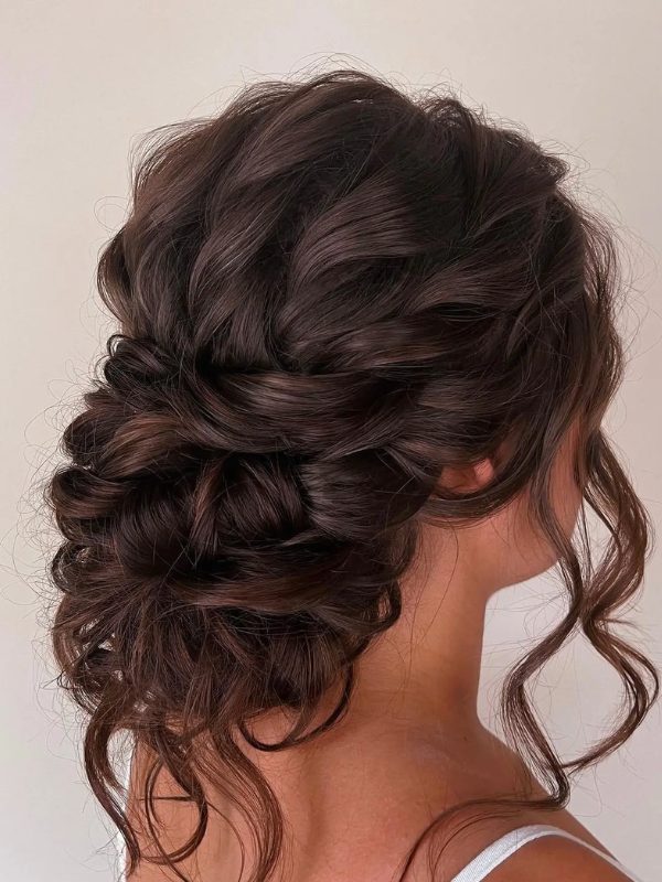 This updo is perfect for brunettes looking to showcase their curls in a sophisticated way