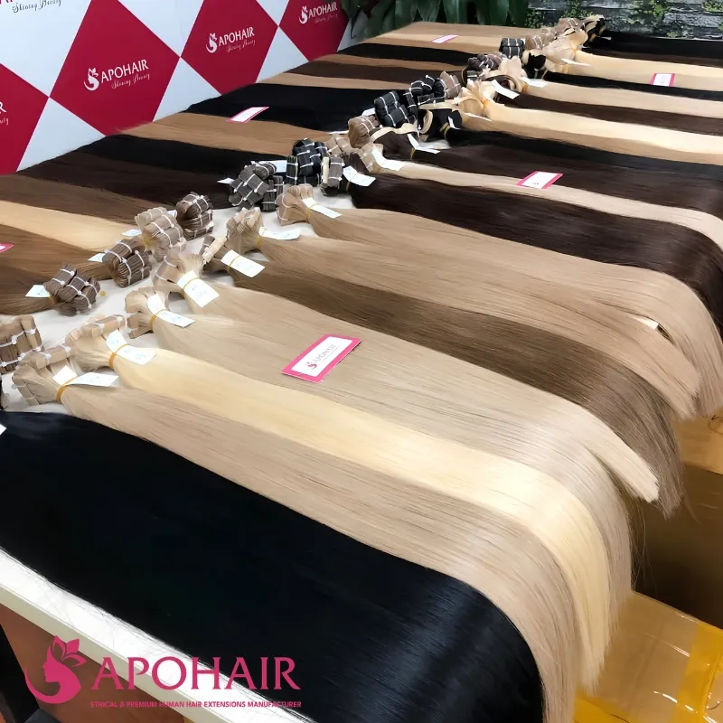 Wholesale straight human hair bundles and extensions in multiple colors displayed at Apohair factory