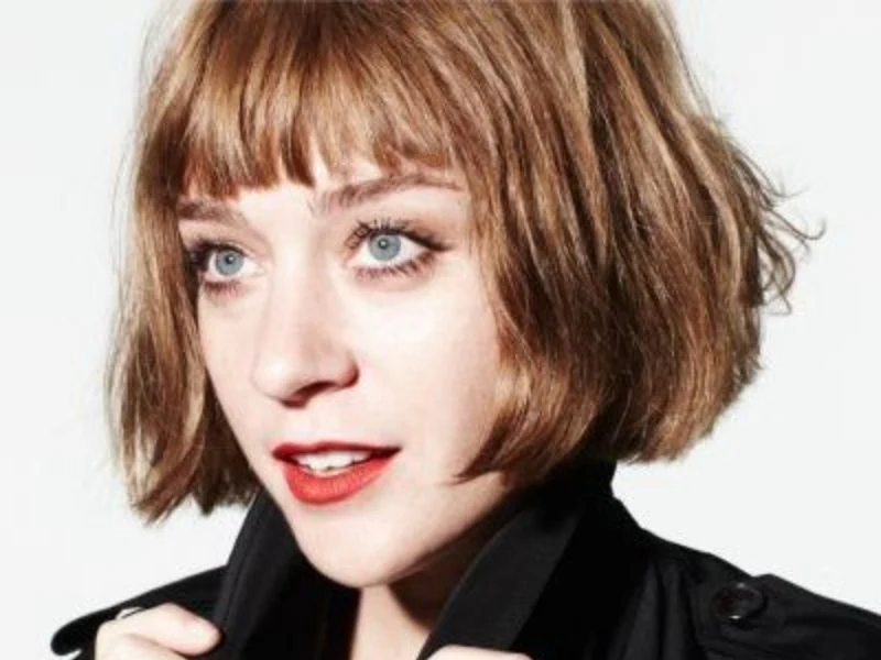 Chloë Sevigny wearing a cheek-width rounded layered bob with a blunt fringe