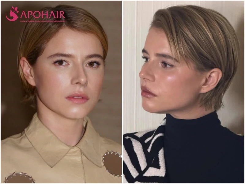 Actress Jessie Buckley wearing a sleek sculpted pixie with a polished, glossy finish