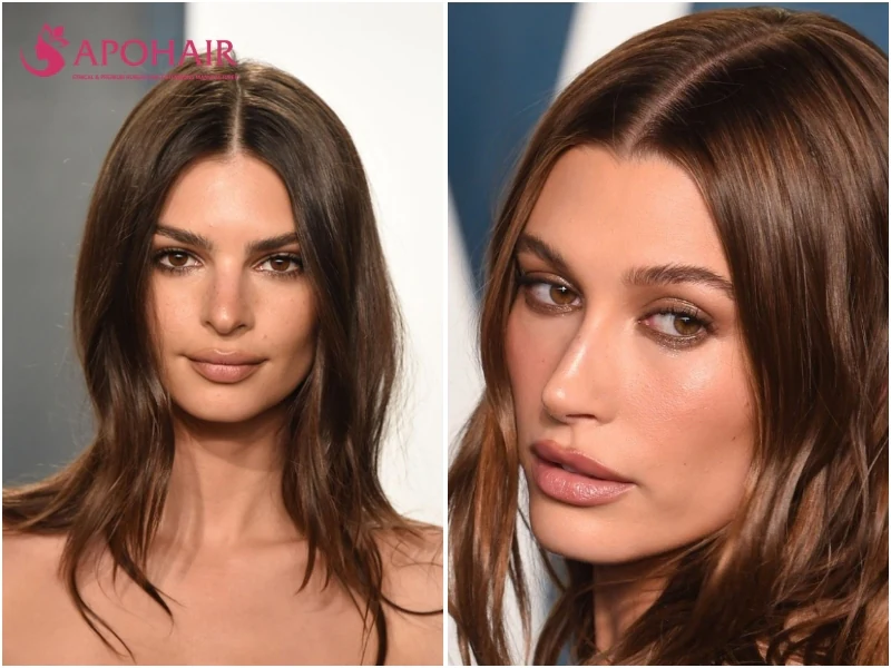 Two women with shoulder-length dark chocolate brown hair parted in the center, on warm skin tones