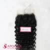 Close-up of a black deep curly closure 5x5 showing the lace base, the part area and tight coils below it